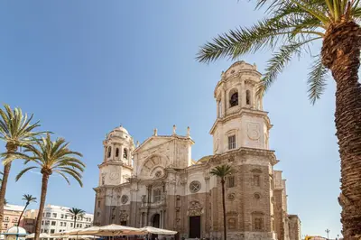 a church with palm trees in front of it at Allo Apartments San Roque 3ºC in Cádiz