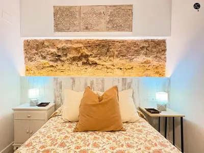 a bedroom with a bed and two night stands at Casita del Mentidero Grupo AC Gestion in Cádiz