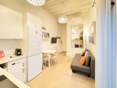 a kitchen and living room with a couch and a table at Casita del Mentidero Grupo AC Gestion in Cádiz