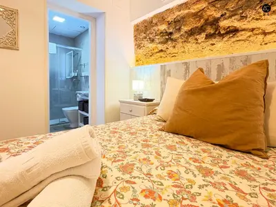 a bedroom with a large bed with a large pillow at Casita del Mentidero Grupo AC Gestion in Cádiz
