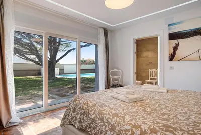 a bedroom with a bed and a large window at CASA DAGO in Chiclana de la Frontera