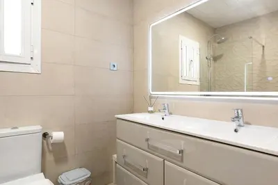 a bathroom with a sink and a mirror at CASA DAGO in Chiclana de la Frontera