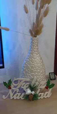 a white vase with flowers in it on a table at Apartamento Catamarán in El Puerto de Santa María