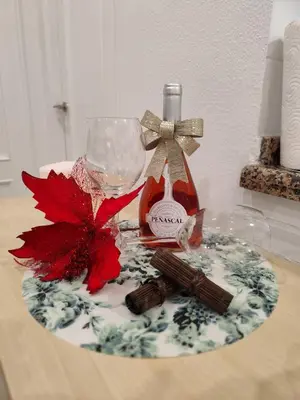 a table with a bottle of wine and a glass at Apartamento Catamarán in El Puerto de Santa María