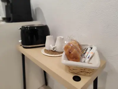 a table with a basket of pastries and a refrigerator at Apartamento Catamarán in El Puerto de Santa María