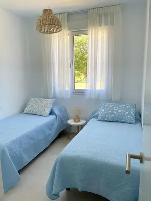 a bedroom with two beds and a window at Apartamento en Costa Ballena in Chipiona