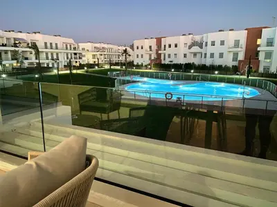 a view of a swimming pool through a window at Apartamento en Costa Ballena in Chipiona