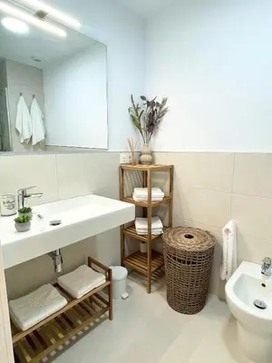 a bathroom with a sink and a toilet and a mirror at Apartamento en Costa Ballena in Chipiona