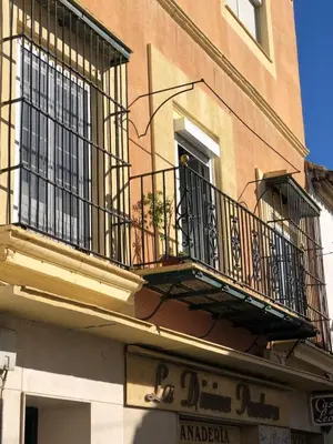 a building with a balcony and a window at Gran casa señorial de 300m en centro histórico in El Puerto de Santa María