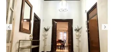 a hallway with two vases and a mirror at Gran casa señorial de 300m en centro histórico in El Puerto de Santa María