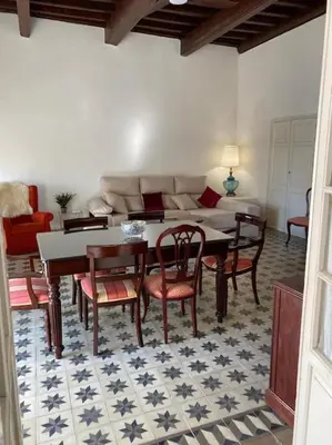 a living room with a table and chairs and a couch at Gran casa señorial de 300m en centro histórico in El Puerto de Santa María