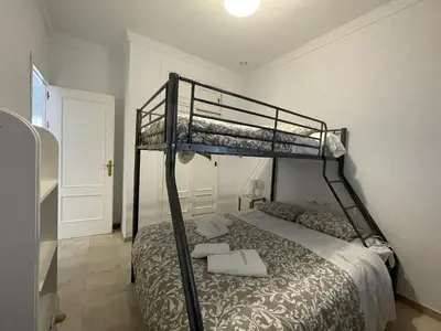 a bedroom with two bunk beds in a room at Chalet Edén Azul in Chiclana de la Frontera