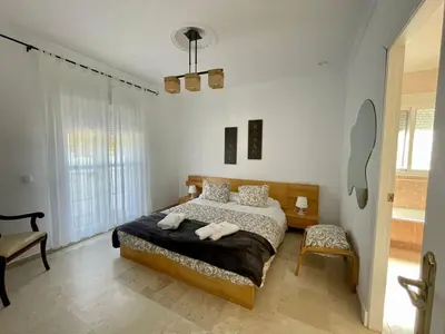 a bedroom with a bed with two towels on it at Chalet Edén Azul in Chiclana de la Frontera
