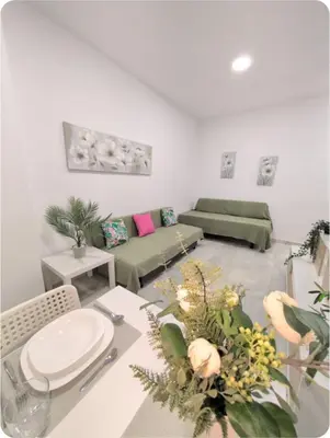 a living room with a table and a couch at Puerto Luxury Centro in El Puerto de Santa María