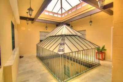 a large bird cage in a room with a window at Puerto Luxury Centro in El Puerto de Santa María