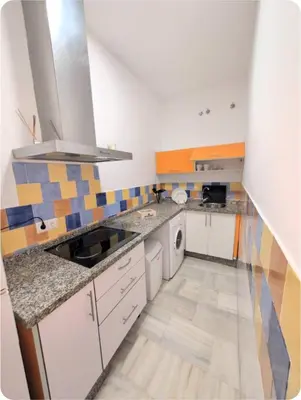 a kitchen with a sink and a counter top at Puerto Luxury Centro in El Puerto de Santa María