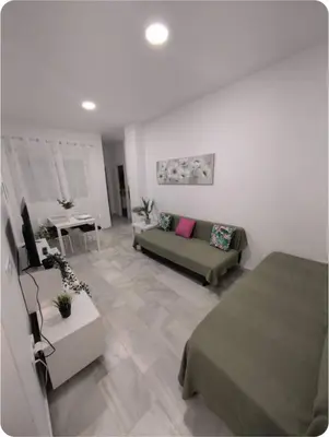 a living room with a couch and a table at Puerto Luxury Centro in El Puerto de Santa María