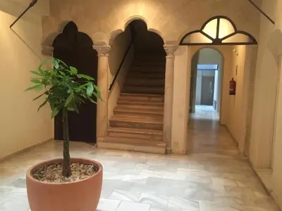 a hallway with a staircase and a potted plant at Puerto Luxury Centro in El Puerto de Santa María