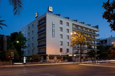 a white building with a sign on top of it at NH Avenida Jerez in Jerez de la Frontera