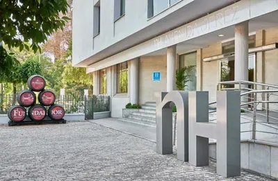 a building with a sign in front of it at NH Avenida Jerez in Jerez de la Frontera