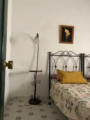 a bedroom with a bed with a lamp on it at Gran casa con balcón para grupos en centro histórico in El Puerto de Santa María