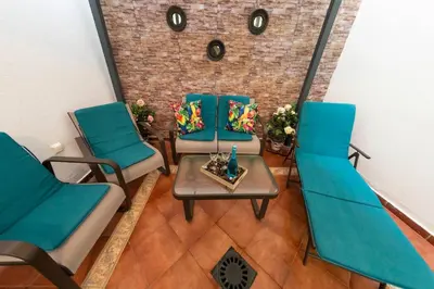 a group of chairs and a table in a room at SH Piluca's Home. Moderno apartamento con patio in Cádiz