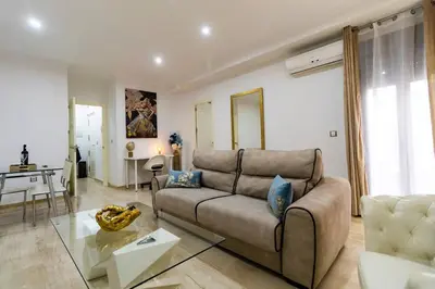 a living room with a couch and a table at SH Piluca's Home. Moderno apartamento con patio in Cádiz