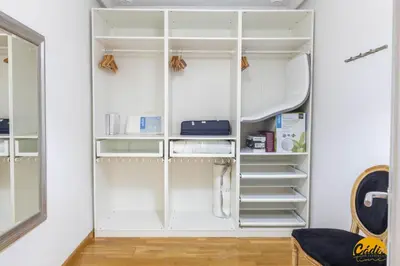 a white closet with white shelving in a room at Balcones del Atlantico - FREE PARKING by Cadiz Time in Cádiz