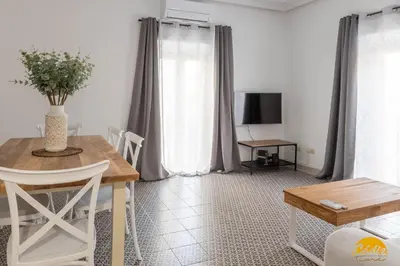 a living room with a table and a television at Balcones del Atlantico - FREE PARKING by Cadiz Time in Cádiz