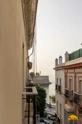 a view of the water from an alley between buildings at Balcones del Atlantico - FREE PARKING by Cadiz Time in Cádiz