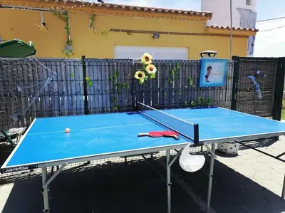 a ping pong table with a tennis ball on it at Chiclana El Principito in Chiclana de la Frontera