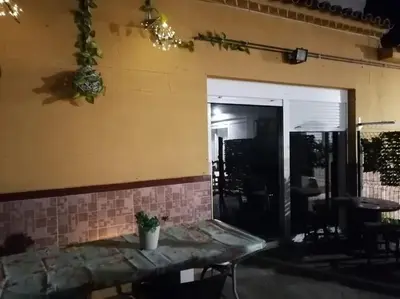 a room with a table with a potted plant on it at Chiclana El Principito in Chiclana de la Frontera