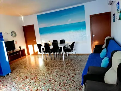 a living room with a dining room table and chairs at Chiclana El Principito in Chiclana de la Frontera