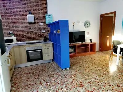 a kitchen with a blue cabinet in a room at Chiclana El Principito in Chiclana de la Frontera