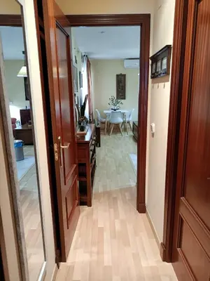 a hallway with a door leading to a dining room at Apartamento la Concha in Chiclana de la Frontera