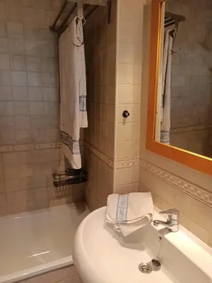 a bathroom with a toilet and a sink and a tub at Apartamento la Concha in Chiclana de la Frontera