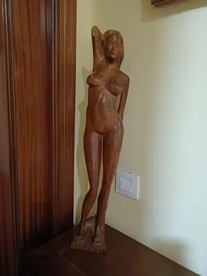 a wooden statue of a woman on a shelf at Apartamento la Concha in Chiclana de la Frontera