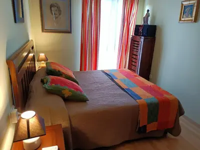 a bedroom with a bed and a window at Apartamento la Concha in Chiclana de la Frontera