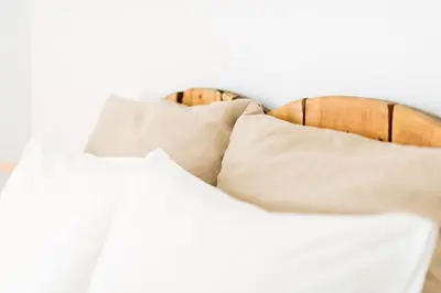 a bed with white pillows on top of it at La Casa Morada in Cádiz