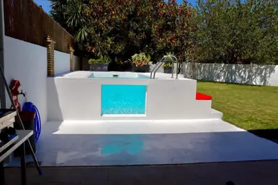 a swimming pool with a fountain in a backyard at Apartamento “Las Cuadras “ in Cádiz