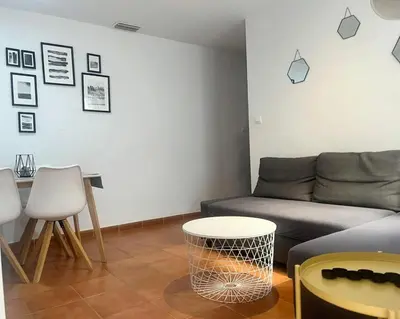 a living room with a couch and a table at Apartamento La Laja 5 min de la playa in Cádiz