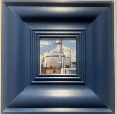 a painting of a factory in a blue frame at Apartamento La Laja 5 min de la playa in Cádiz
