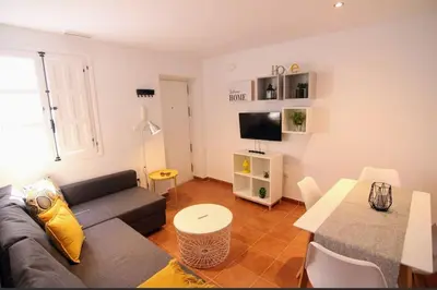 a living room with a couch and a table at Apartamento La Laja 5 min de la playa in Cádiz