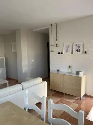 a living room with a couch and a table and chairs at SlowHome Rota in Rota