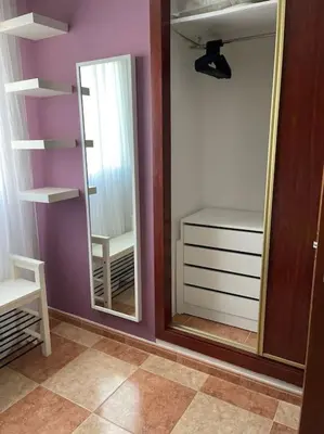 a room with two mirrors and a closet with a chair at SlowHome Rota in Rota
