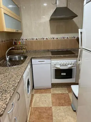 a kitchen with a white stove and a sink at SlowHome Rota in Rota
