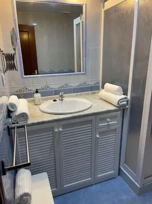 a bathroom with a sink and a mirror at SlowHome Rota in Rota