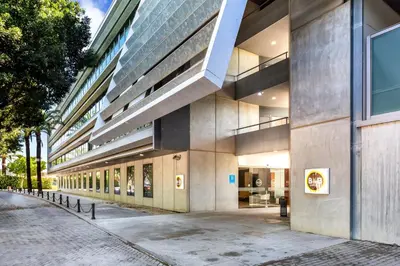 a large building on a sidewalk next to a street at B&B HOTEL Jerez in Jerez de la Frontera
