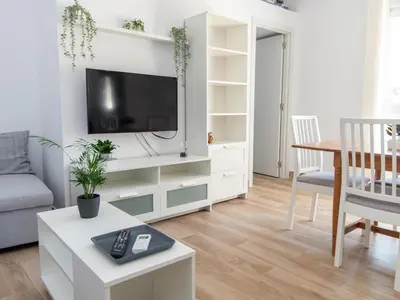 a kitchen with a white refrigerator and a white counter top at GuestReady - Blanca Paloma Ana in El Puerto de Santa María