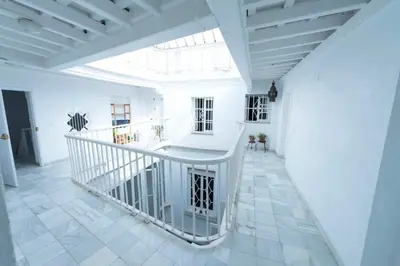 a white room with a staircase and a window at Apartamento 